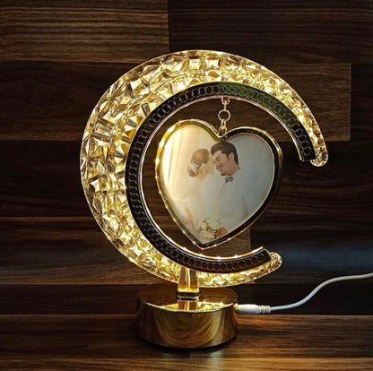Decorative lamp with a heart-shaped photo frame on a wooden surface