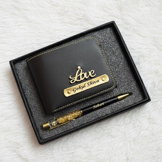 Black wallet and pen set with 'Love' engraving in a box on a white textured background